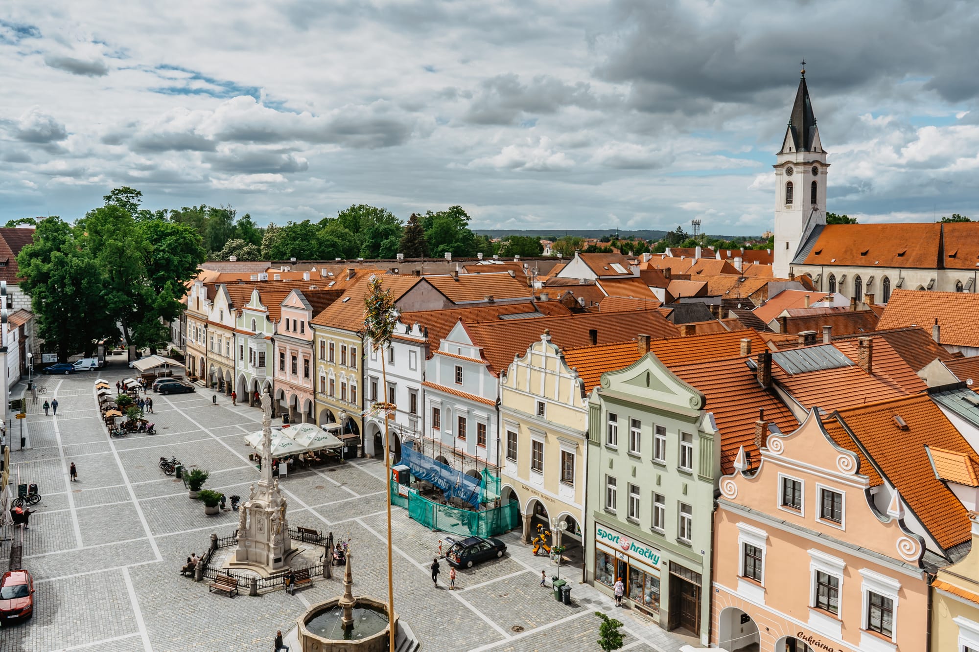 Trebon,Czech republic - May 28,2021. Aerial view of popular spa town in south Bohemia.Houses with colorful facades,red roofs,main square,church in background.Spend active vacation on bikes.