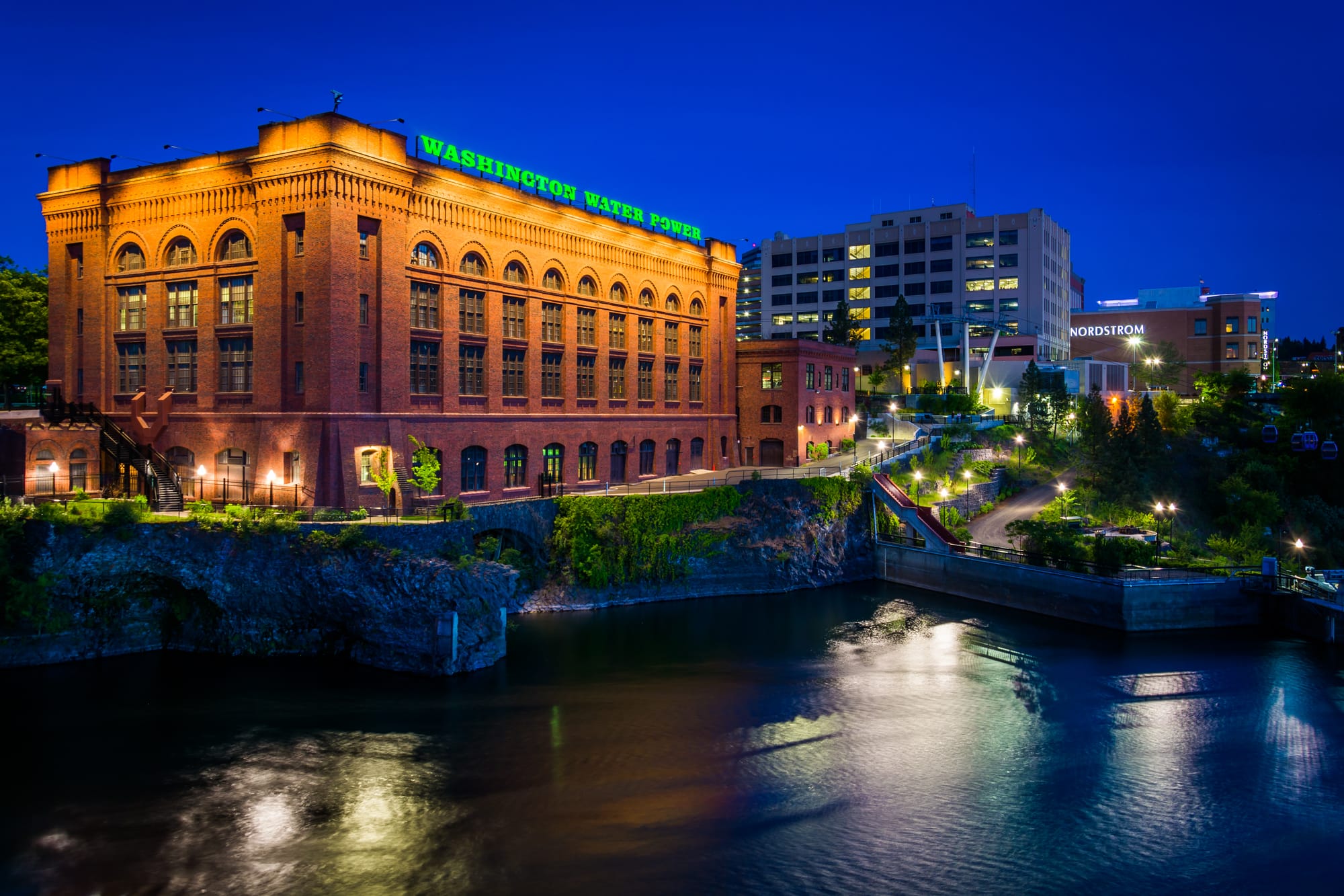 Buildings along the Spokane River at night, in Spokane, Washingt